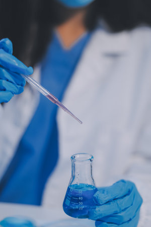 Research, experiment and medical trial being done by a scientist in a lab, science facility or hospital. One young, serious and professional researcher organizing, sorting or making a discoveryの写真素材