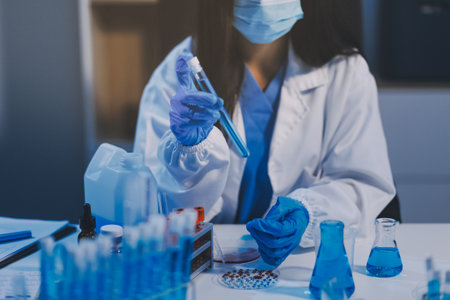 Research, experiment and medical trial being done by a scientist in a lab, science facility or hospital. One young, serious and professional researcher organizing, sorting or making a discoveryの写真素材