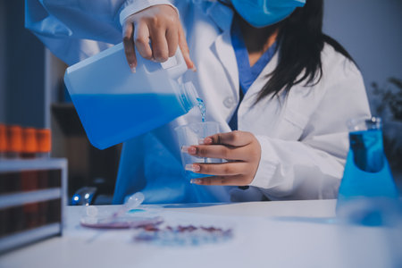Research, experiment and medical trial being done by a scientist in a lab, science facility or hospital. One young, serious and professional researcher organizing, sorting or making a discoveryの写真素材