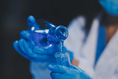 Research, experiment and medical trial being done by a scientist in a lab, science facility or hospital. One young, serious and professional researcher organizing, sorting or making a discoveryの写真素材