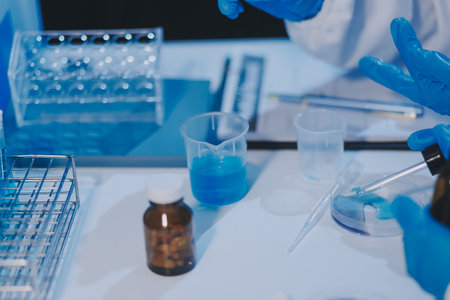 Research, experiment and medical trial being done by a scientist in a lab, science facility or hospital. One young, serious and professional researcher organizing, sorting or making a discoveryの写真素材