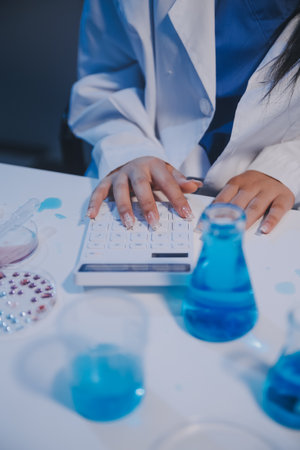 Research, experiment and medical trial being done by a scientist in a lab, science facility or hospital. One young, serious and professional researcher organizing, sorting or making a discoveryの写真素材