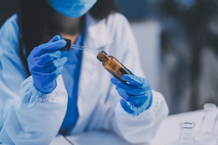 Research, experiment and medical trial being done by a scientist in a lab, science facility or hospital. One young, serious and professional researcher organizing, sorting or making a discoveryの写真素材