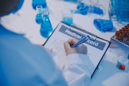 Research, experiment and medical trial being done by a scientist in a lab, science facility or hospital. One young, serious and professional researcher organizing, sorting or making a discoveryの写真素材