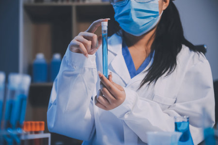 Research, experiment and medical trial being done by a scientist in a lab, science facility or hospital. One young, serious and professional researcher organizing, sorting or making a discoveryの写真素材