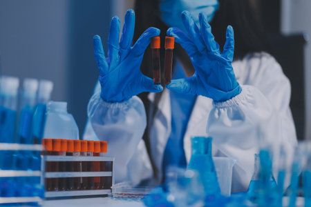 Research, experiment and medical trial being done by a scientist in a lab, science facility or hospital. One young, serious and professional researcher organizing, sorting or making a discoveryの写真素材