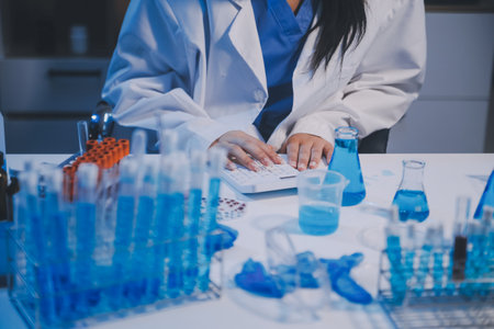 Research, experiment and medical trial being done by a scientist in a lab, science facility or hospital. One young, serious and professional researcher organizing, sorting or making a discoveryの写真素材
