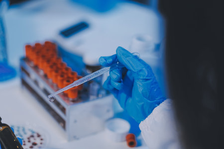 Research, experiment and medical trial being done by a scientist in a lab, science facility or hospital. One young, serious and professional researcher organizing, sorting or making a discoveryの写真素材