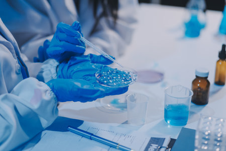 Research, experiment and medical trial being done by a scientist in a lab, science facility or hospital. One young, serious and professional researcher organizing, sorting or making a discoveryの写真素材