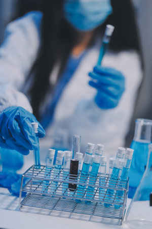 Research, experiment and medical trial being done by a scientist in a lab, science facility or hospital. One young, serious and professional researcher organizing, sorting or making a discoveryの写真素材