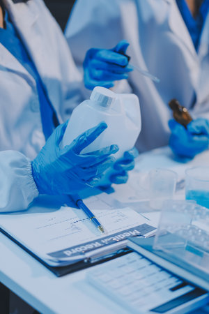 Research, experiment and medical trial being done by a scientist in a lab, science facility or hospital. One young, serious and professional researcher organizing, sorting or making a discoveryの写真素材
