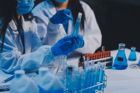 Research, experiment and medical trial being done by a scientist in a lab, science facility or hospital. One young, serious and professional researcher organizing, sorting or making a discoveryの写真素材