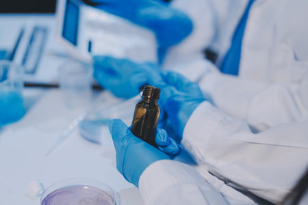 Research, experiment and medical trial being done by a scientist in a lab, science facility or hospital. One young, serious and professional researcher organizing, sorting or making a discoveryの写真素材