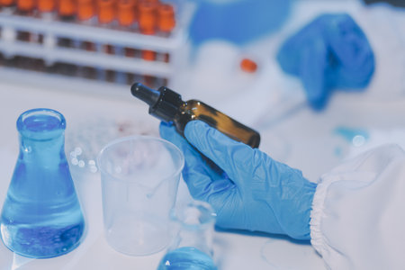 Research, experiment and medical trial being done by a scientist in a lab, science facility or hospital. One young, serious and professional researcher organizing, sorting or making a discoveryの写真素材