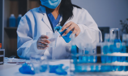 Research, experiment and medical trial being done by a scientist in a lab, science facility or hospital. One young, serious and professional researcher organizing, sorting or making a discoveryの写真素材