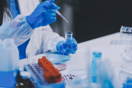 Research, experiment and medical trial being done by a scientist in a lab, science facility or hospital. One young, serious and professional researcher organizing, sorting or making a discoveryの写真素材