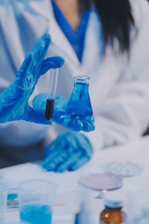 Research, experiment and medical trial being done by a scientist in a lab, science facility or hospital. One young, serious and professional researcher organizing, sorting or making a discoveryの写真素材