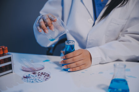 Research, experiment and medical trial being done by a scientist in a lab, science facility or hospital. One young, serious and professional researcher organizing, sorting or making a discoveryの写真素材