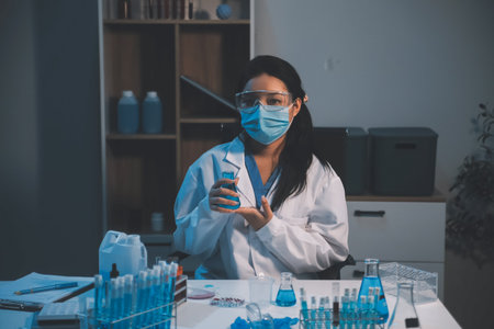 Research, experiment and medical trial being done by a scientist in a lab, science facility or hospital. One young, serious and professional researcher organizing, sorting or making a discoveryの写真素材