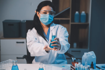 Research, experiment and medical trial being done by a scientist in a lab, science facility or hospital. One young, serious and professional researcher organizing, sorting or making a discoveryの写真素材