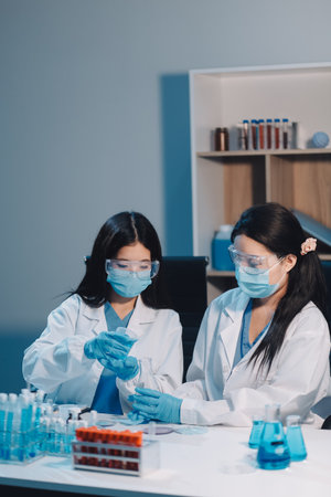 Research, experiment and medical trial being done by a scientist in a lab, science facility or hospital. One young, serious and professional researcher organizing, sorting or making a discoveryの写真素材