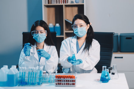 Research, experiment and medical trial being done by a scientist in a lab, science facility or hospital. One young, serious and professional researcher organizing, sorting or making a discoveryの写真素材