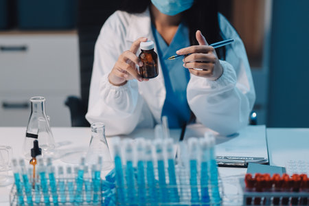 Research, experiment and medical trial being done by a scientist in a lab, science facility or hospital. One young, serious and professional researcher organizing, sorting or making a discoveryの写真素材