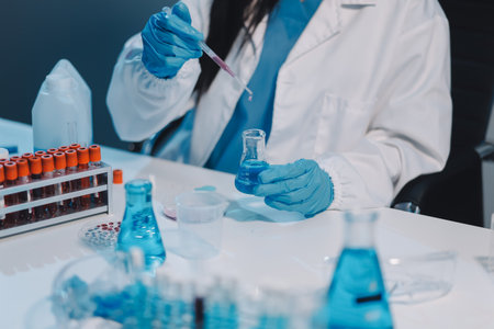 Research, experiment and medical trial being done by a scientist in a lab, science facility or hospital. One young, serious and professional researcher organizing, sorting or making a discoveryの写真素材