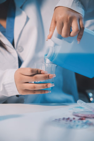 Research, experiment and medical trial being done by a scientist in a lab, science facility or hospital. One young, serious and professional researcher organizing, sorting or making a discoveryの写真素材