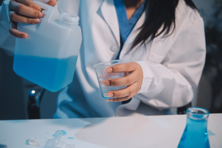 Research, experiment and medical trial being done by a scientist in a lab, science facility or hospital. One young, serious and professional researcher organizing, sorting or making a discoveryの写真素材