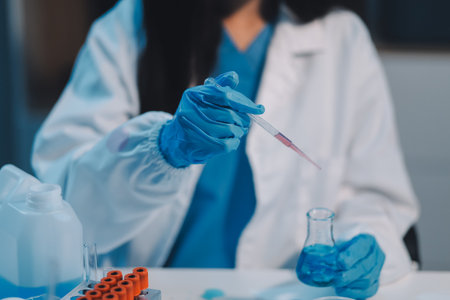 Research, experiment and medical trial being done by a scientist in a lab, science facility or hospital. One young, serious and professional researcher organizing, sorting or making a discoveryの写真素材