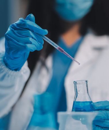Research, experiment and medical trial being done by a scientist in a lab, science facility or hospital. One young, serious and professional researcher organizing, sorting or making a discoveryの写真素材