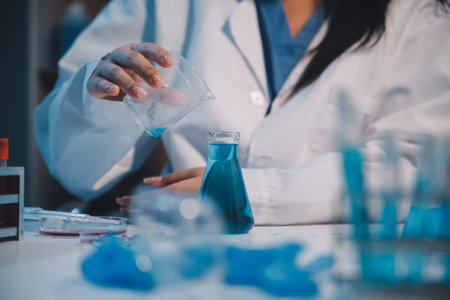 Research, experiment and medical trial being done by a scientist in a lab, science facility or hospital. One young, serious and professional researcher organizing, sorting or making a discoveryの写真素材