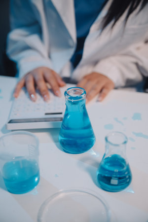Research, experiment and medical trial being done by a scientist in a lab, science facility or hospital. One young, serious and professional researcher organizing, sorting or making a discoveryの写真素材