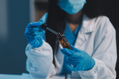 Research, experiment and medical trial being done by a scientist in a lab, science facility or hospital. One young, serious and professional researcher organizing, sorting or making a discoveryの写真素材