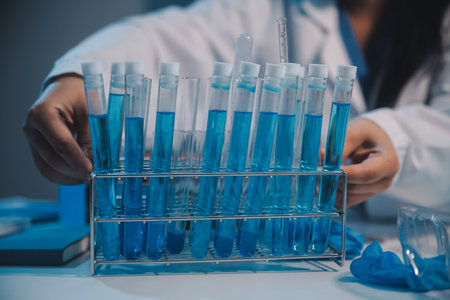 Research, experiment and medical trial being done by a scientist in a lab, science facility or hospital. One young, serious and professional researcher organizing, sorting or making a discoveryの写真素材