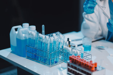 Research, experiment and medical trial being done by a scientist in a lab, science facility or hospital. One young, serious and professional researcher organizing, sorting or making a discoveryの写真素材