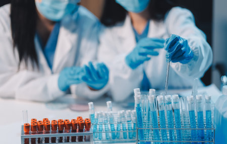 Research, experiment and medical trial being done by a scientist in a lab, science facility or hospital. One young, serious and professional researcher organizing, sorting or making a discoveryの写真素材