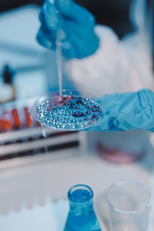 Research, experiment and medical trial being done by a scientist in a lab, science facility or hospital. One young, serious and professional researcher organizing, sorting or making a discoveryの写真素材