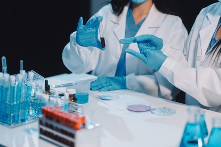 Research, experiment and medical trial being done by a scientist in a lab, science facility or hospital. One young, serious and professional researcher organizing, sorting or making a discoveryの写真素材