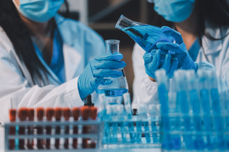 Research, experiment and medical trial being done by a scientist in a lab, science facility or hospital. One young, serious and professional researcher organizing, sorting or making a discoveryの写真素材