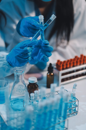 Research, experiment and medical trial being done by a scientist in a lab, science facility or hospital. One young, serious and professional researcher organizing, sorting or making a discoveryの写真素材