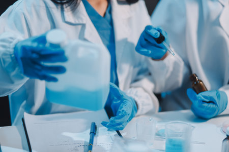 Research, experiment and medical trial being done by a scientist in a lab, science facility or hospital. One young, serious and professional researcher organizing, sorting or making a discoveryの写真素材