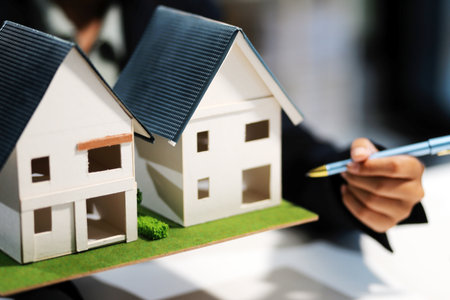 Real estate agents explain models of housing estates in projects to elaborate to clients, explaining and presenting information about homes and purchasing loans. Real estate trading concept.の写真素材