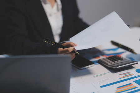 Audit concept,Administrator business man financial inspector and secretary making report calculating balance. Internal Revenue Service checking document.の写真素材