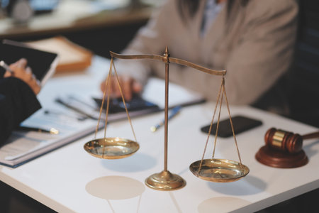 Consultation and conference of lawyers and professional businessman working and discussion having at law firm in office. Concepts of law, Judge gavel with scales of justice.の写真素材