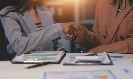 Man and woman are shaking hands in office. Collaborative teamwork.の写真素材
