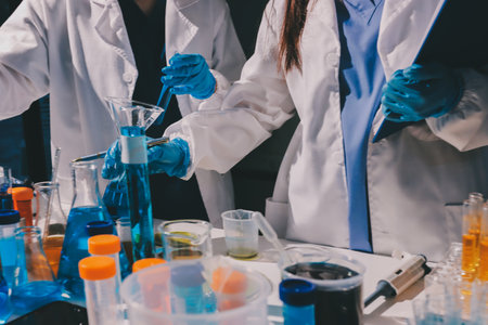 Scientist pipetting medical samples into microplate in laboratoryの写真素材