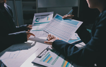 Group of business women working on a financial data expenses document.の写真素材