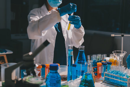 Scientist pipetting medical samples into microplate in laboratoryの写真素材